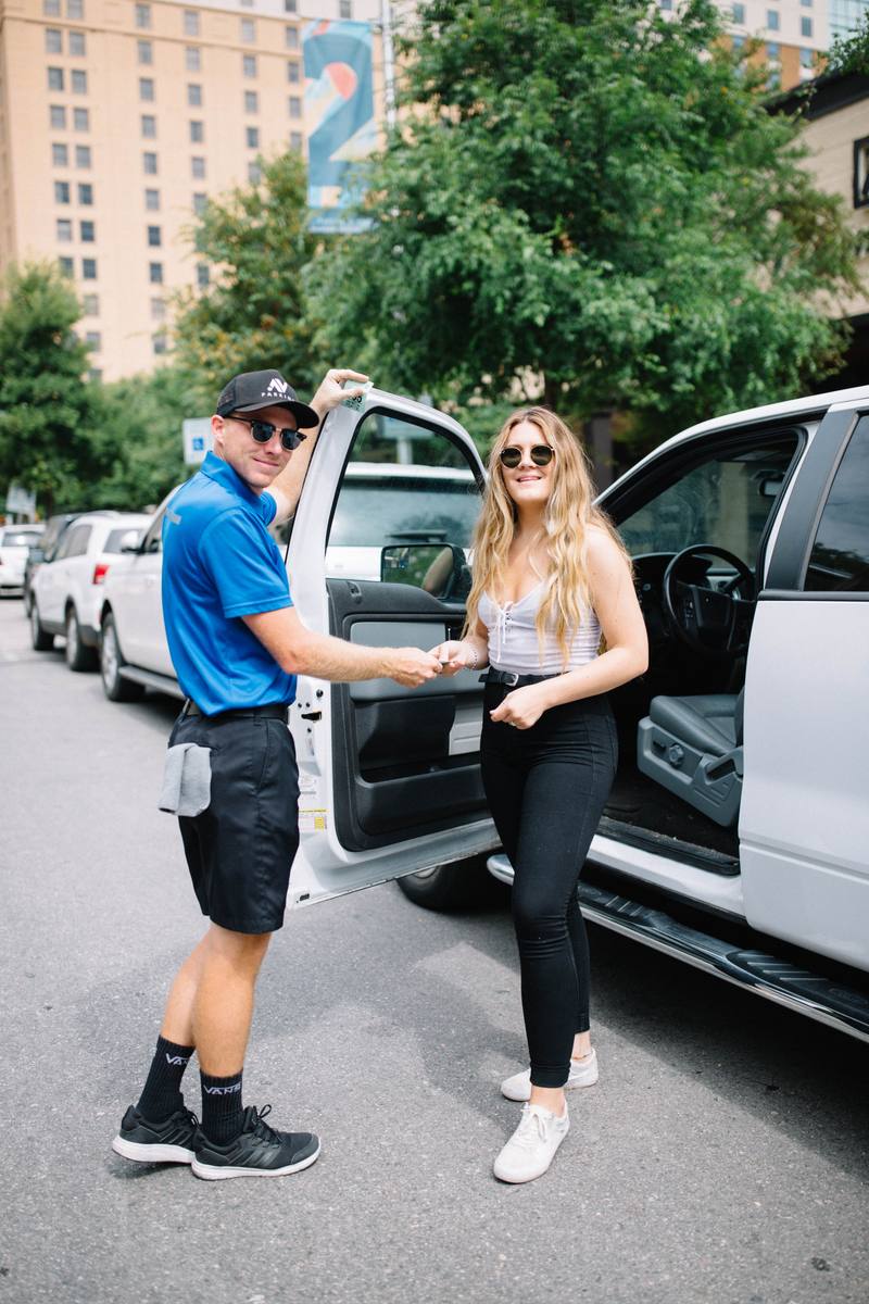 Valet attendant assisting guest at event venue