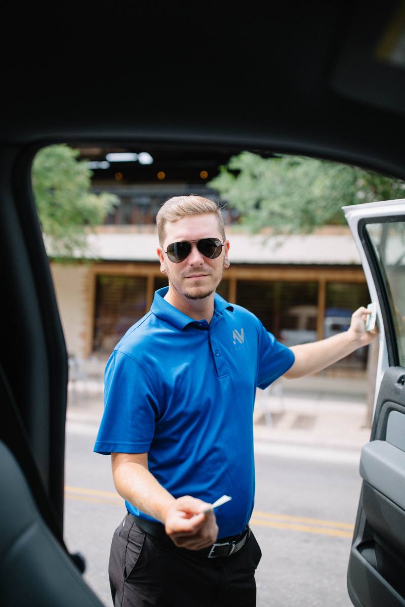 Valet attendant greeting driver at corporate facility